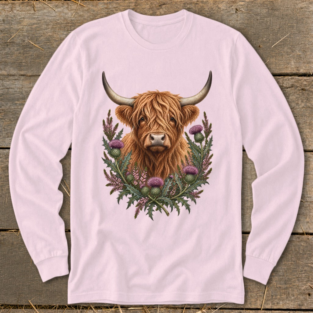 Long-sleeved pink shirt featuring a watercolor highland cow surrounded by thistles.
