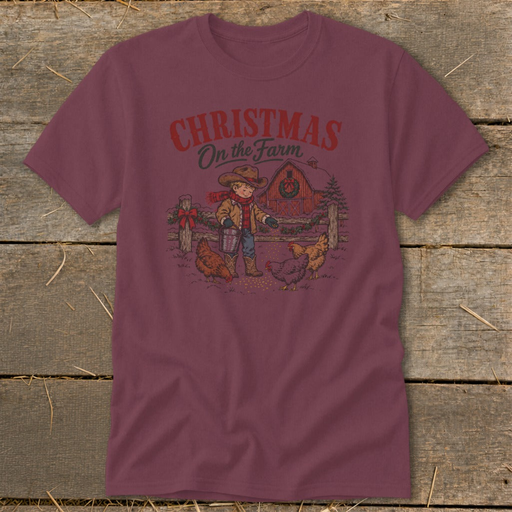 T-shirt graphic with text "Christmas on the Farm" shows a boy feeding chickens.