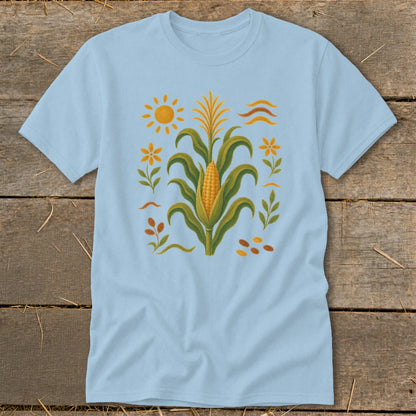 Light blue t-shirt with a corn stalk, sun, and floral design.