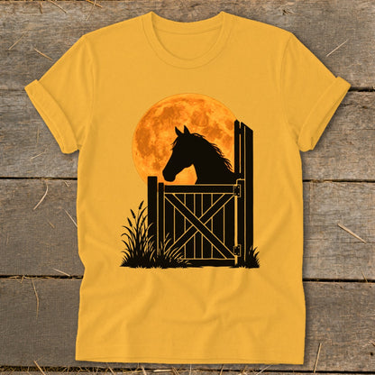 A golden yellow short-sleeved t-shirt featuring a black silhouette of a horse looking over a stall gate against a large orange moon.