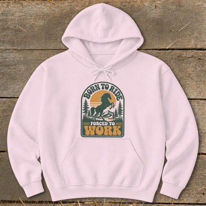 Pink hoodie with a distressed graphic featuring a horse, trees, and text that reads "Born to Ride, Forced to Work".