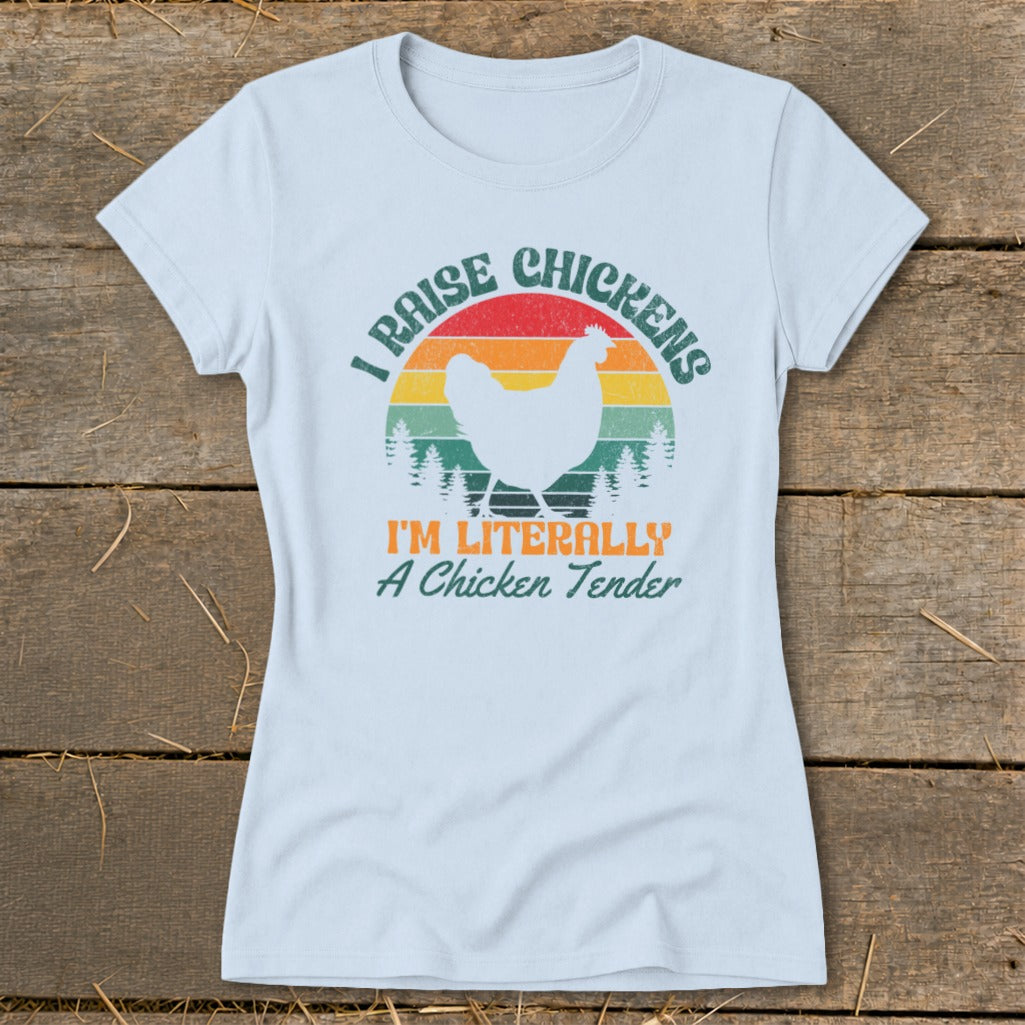 Light blue t-shirt with a chicken silhouette, rainbow, trees, and text.
