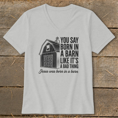 Grey v-neck t-shirt with barn graphic and text about Jesus' birth.