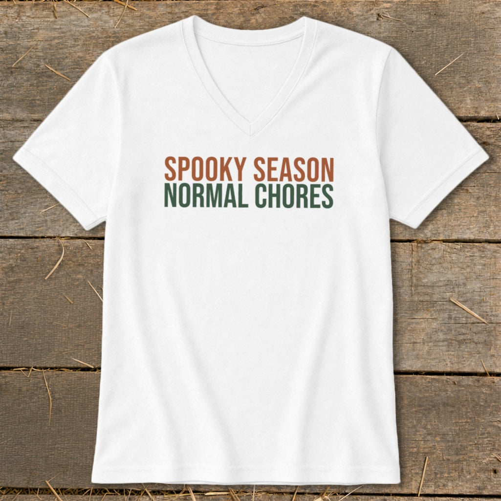 White v-neck t-shirt with "SPOOKY SEASON NORMAL CHORES" text.