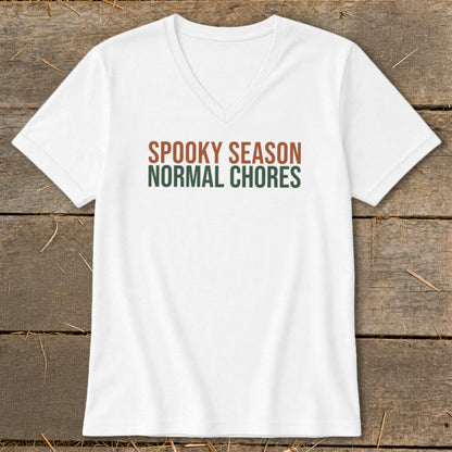 White v-neck t-shirt with "SPOOKY SEASON NORMAL CHORES" text.