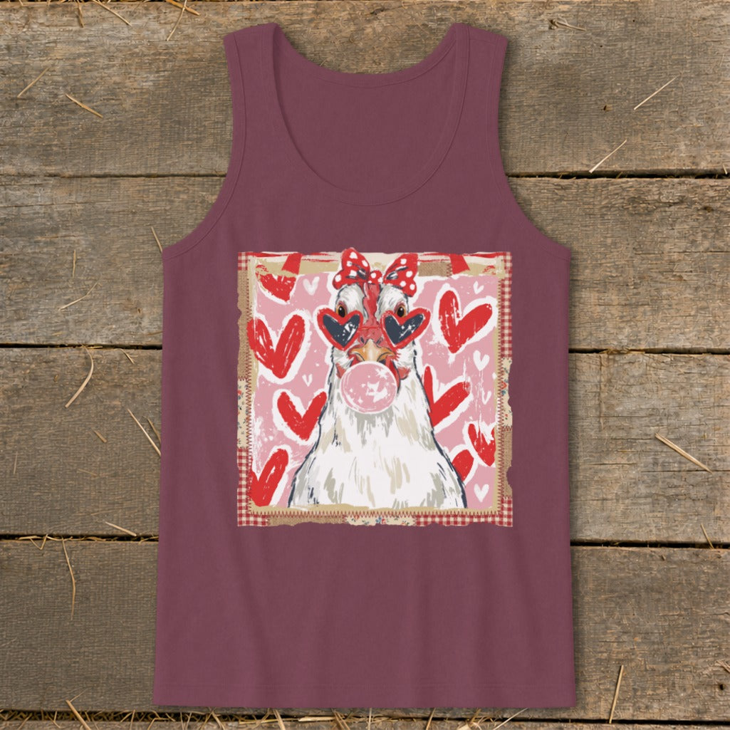 Chicken in heart sunglasses blows pink bubblegum with red hearts background.