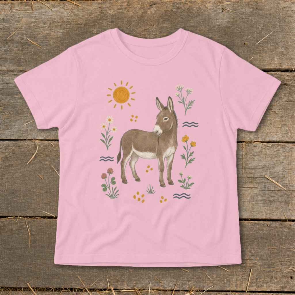 Pink t-shirt featuring a brown donkey illustration surrounded by flowers and the sun.