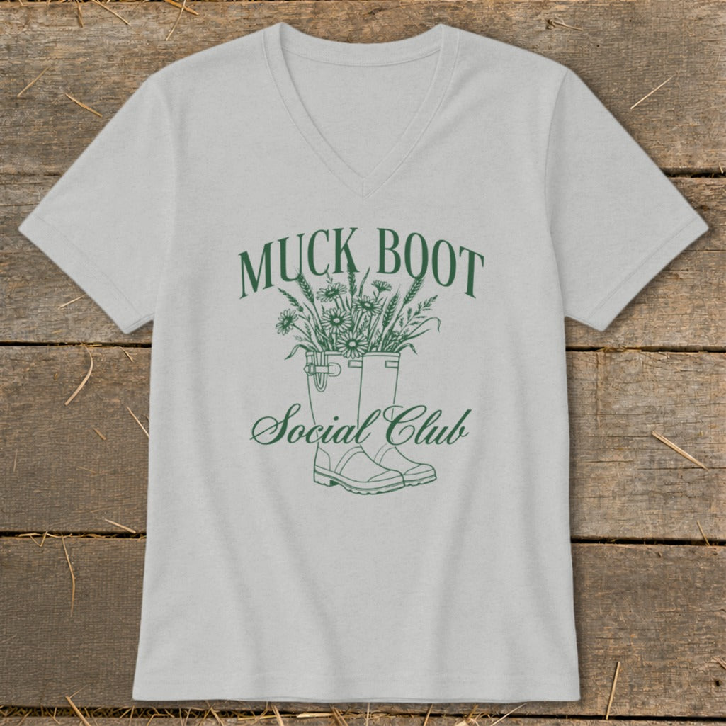 Grey t-shirt with green "Muck Boot Social Club" text and floral design.