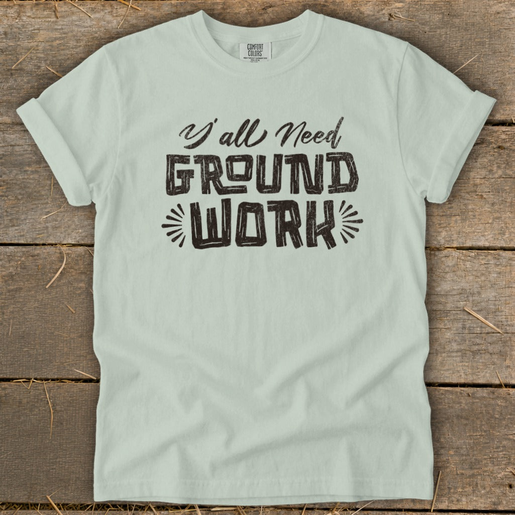 Light green t-shirt with "Y'all Need GROUND WORK" text graphic.