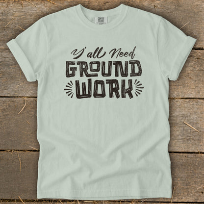 Light green t-shirt with "Y'all Need GROUND WORK" text graphic.