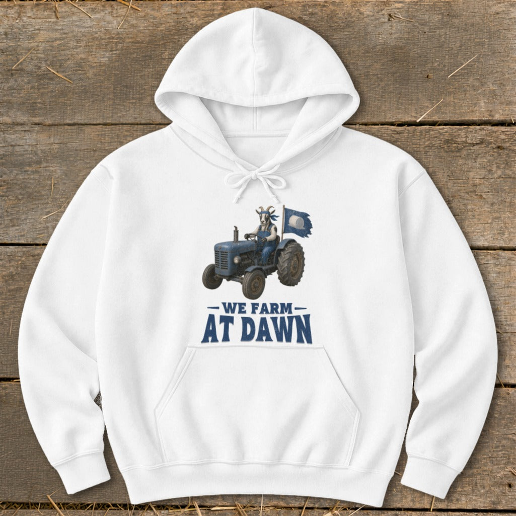 White hoodie with a goat driving a blue tractor and the text "WE FARM AT DAWN".