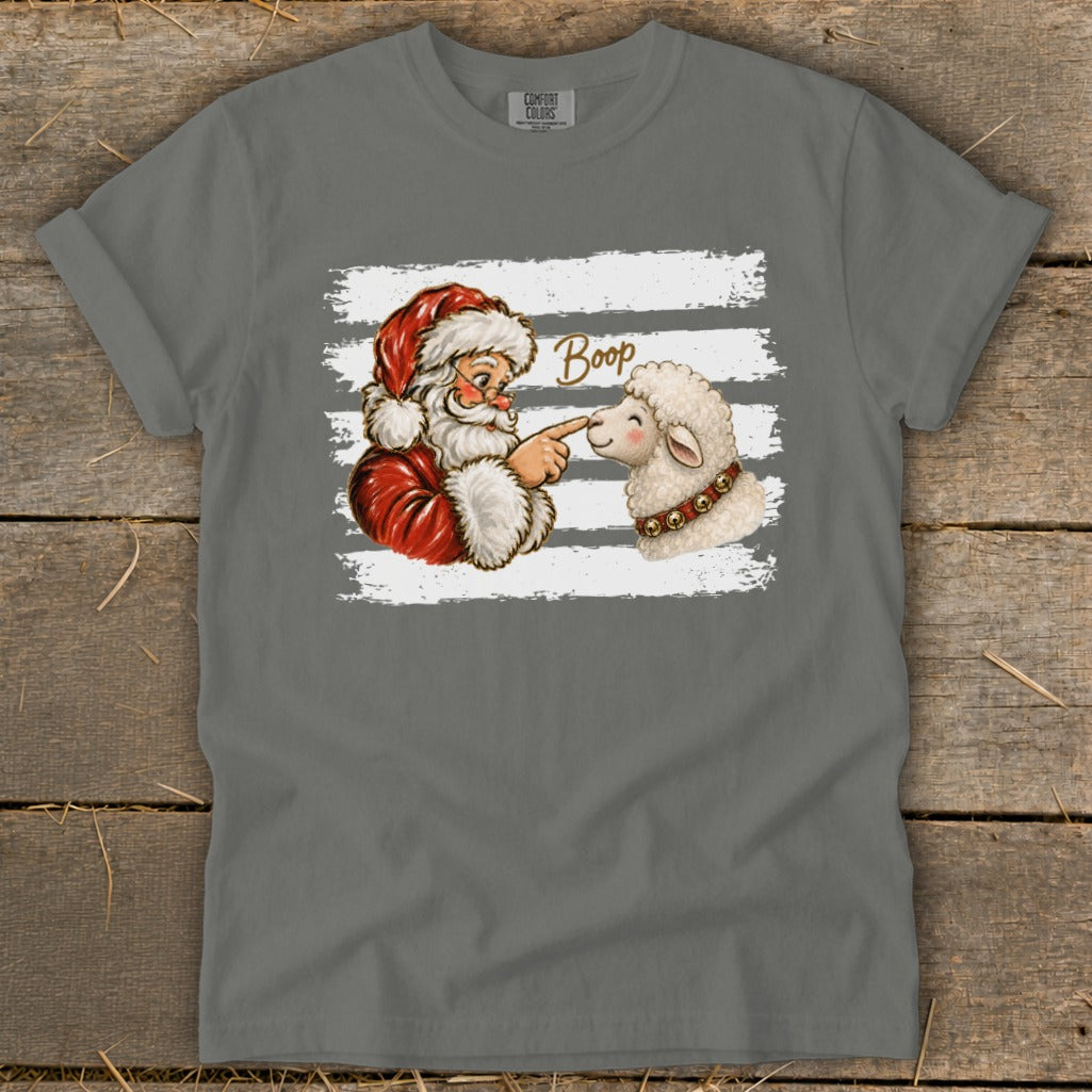 Santa booping a sheep's nose with the word "Boop" above.