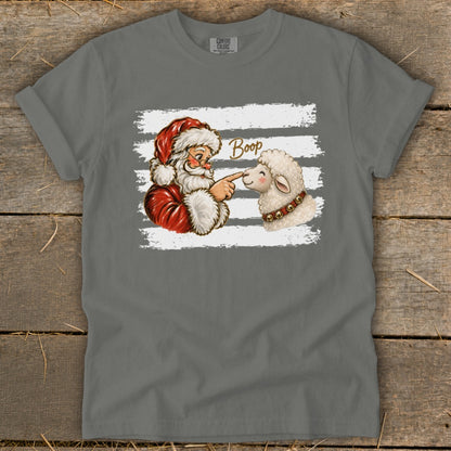 Santa booping a sheep's nose with the word "Boop" above.