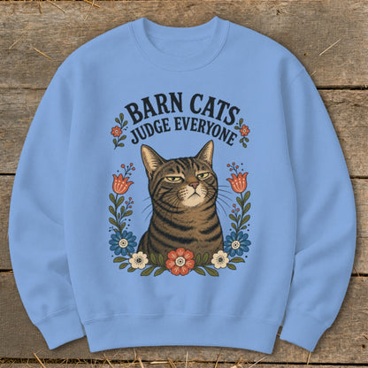 Light blue sweatshirt with a tabby cat graphic and text "Barn Cats Judge Everyone."