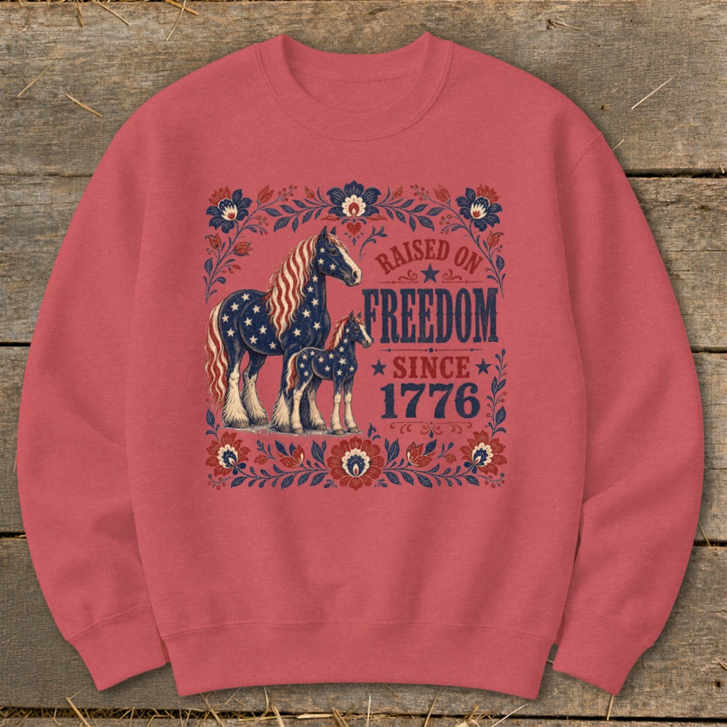 Crewneck sweatshirt with horses and "Raised on Freedom Since 1776" text.