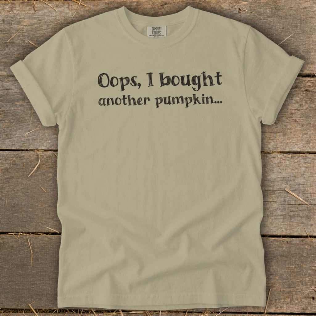 Light tan t-shirt with black text that reads "Oops, I bought another pumpkin..."