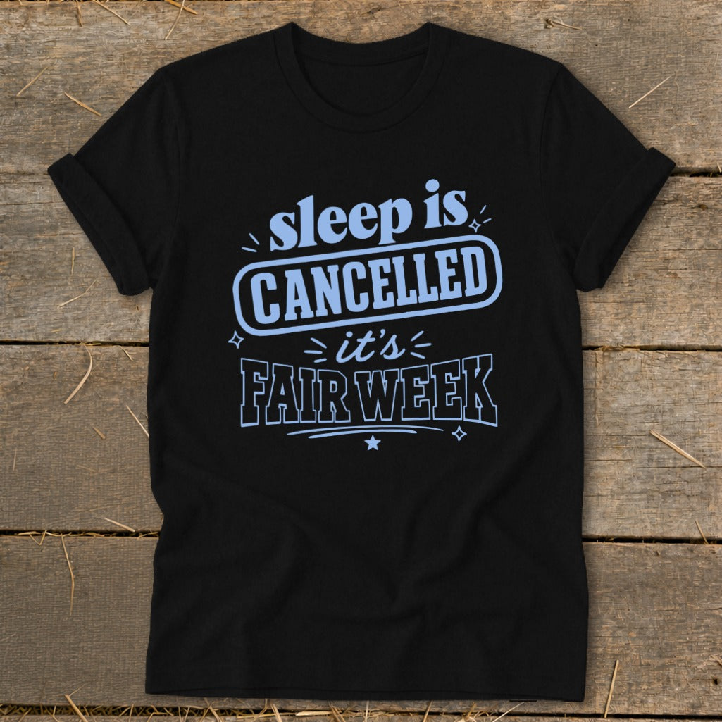 Black t-shirt with light blue text: "sleep is CANCELLED it's FAIR WEEK".