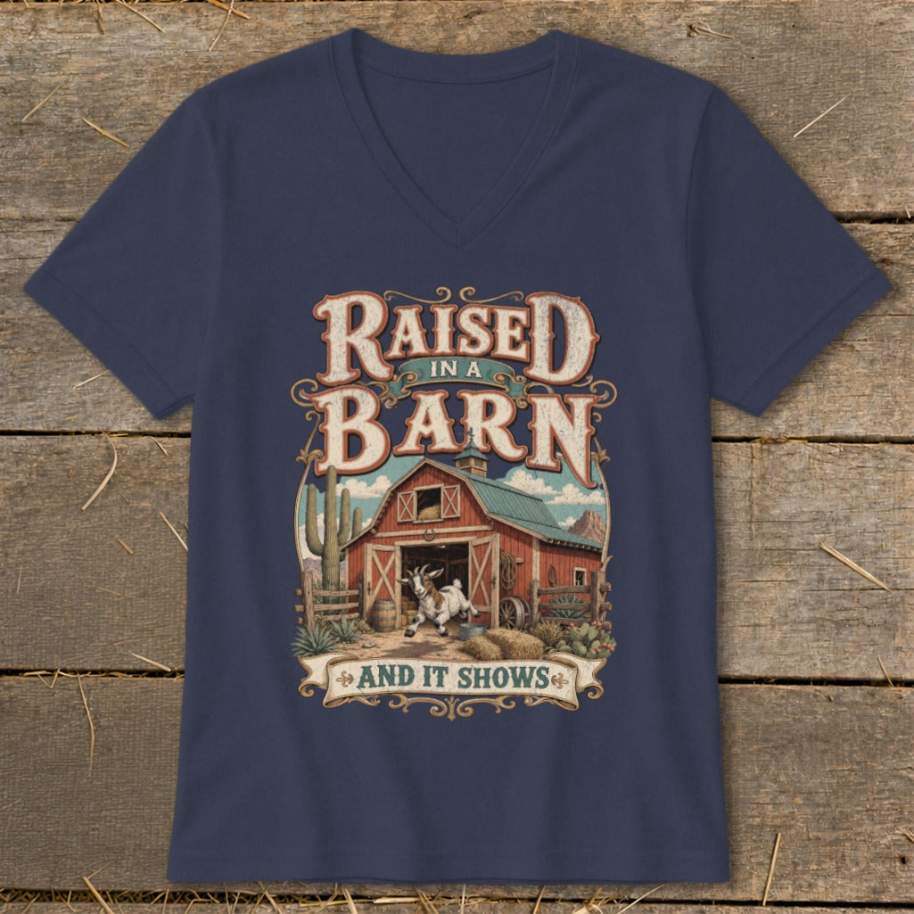 Navy v-neck shirt with "Raised in a Barn and It Shows" graphic and goat.