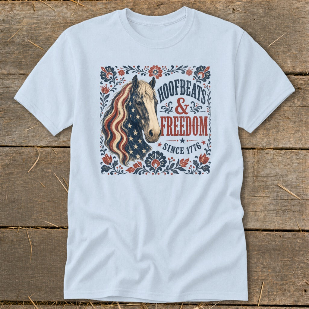 Light blue t-shirt with horse graphic and text "Hoofbeats & Freedom Since 1776".