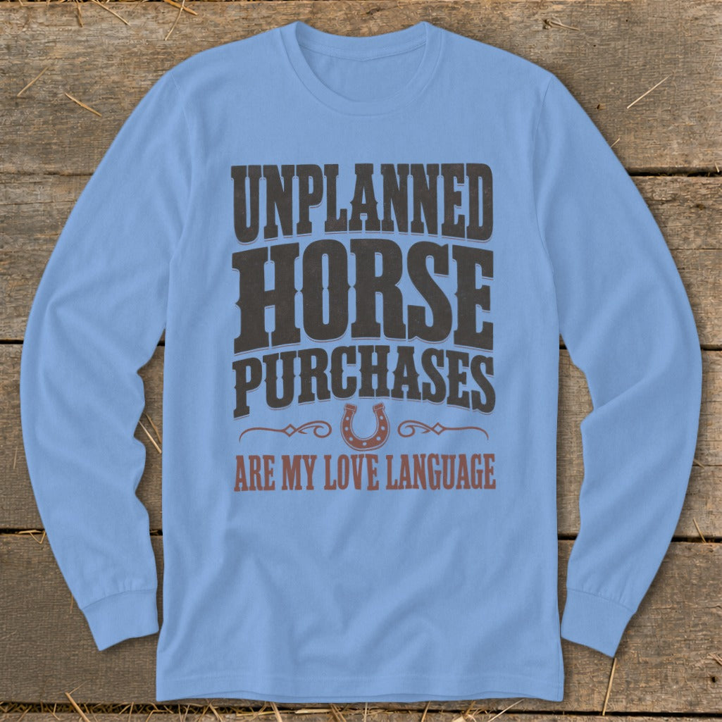 Light blue long-sleeve shirt with "UNPLANNED HORSE PURCHASES ARE MY LOVE LANGUAGE" text.