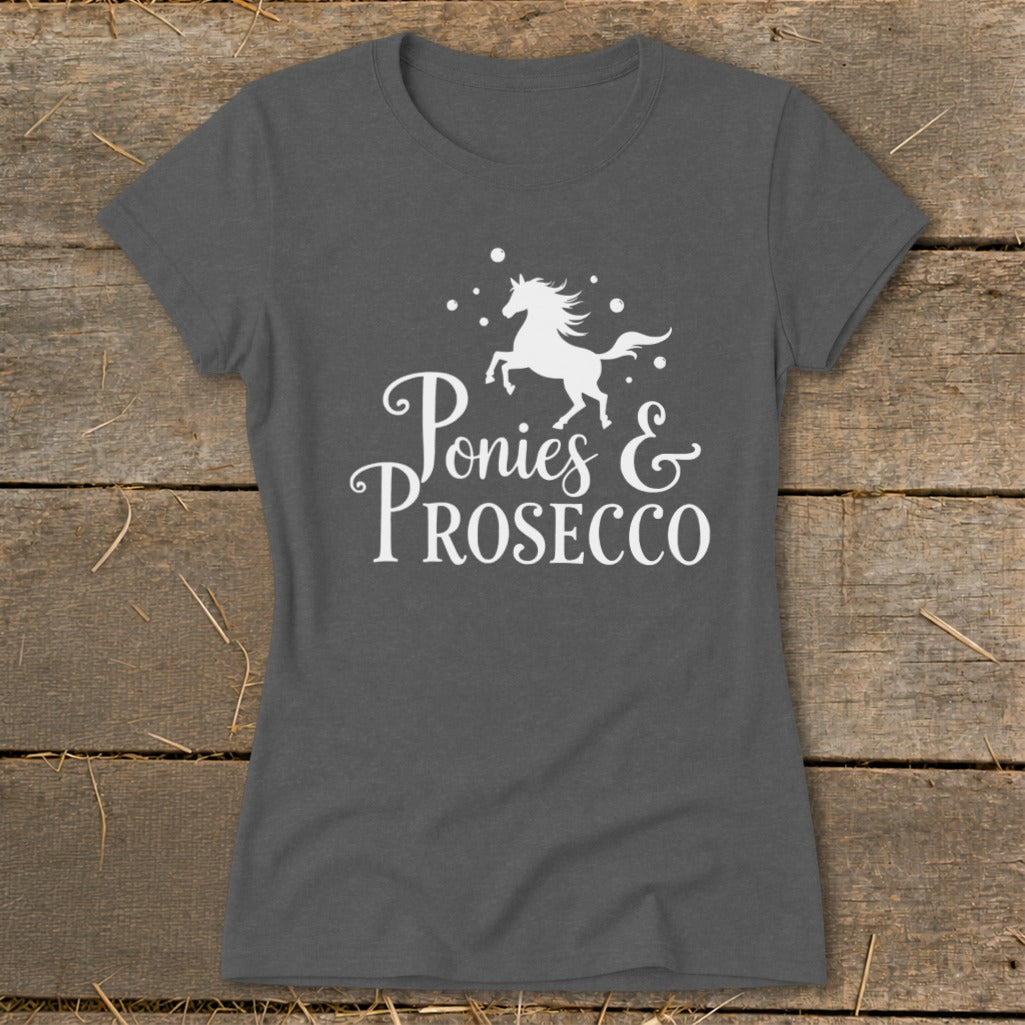 Dark gray t-shirt with white text "Ponies & Prosecco" and a horse graphic.