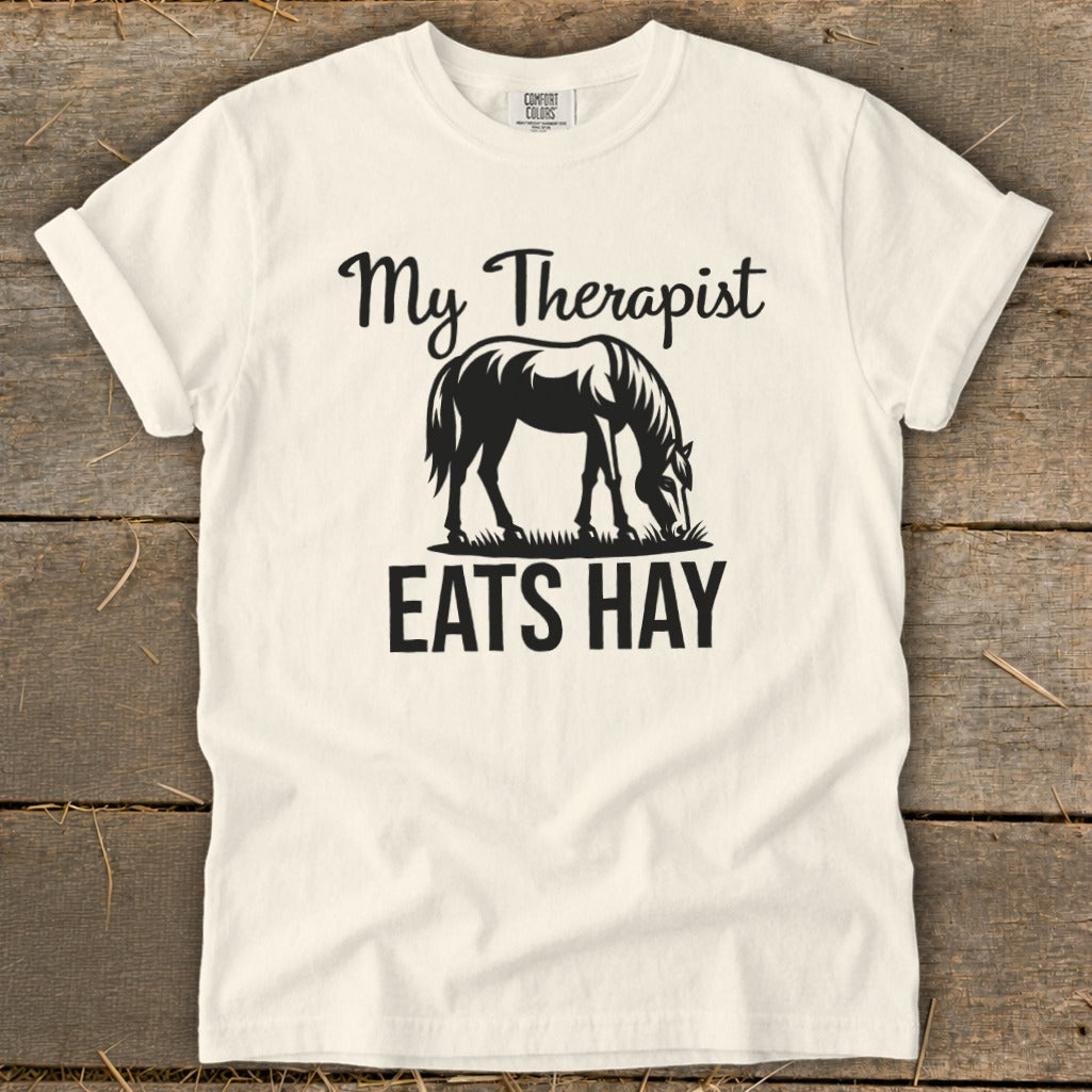 Cream t-shirt with black text and horse graphic: "My Therapist EATS HAY".