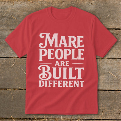 Red t-shirt with white text: "Mare People Are Built Different".