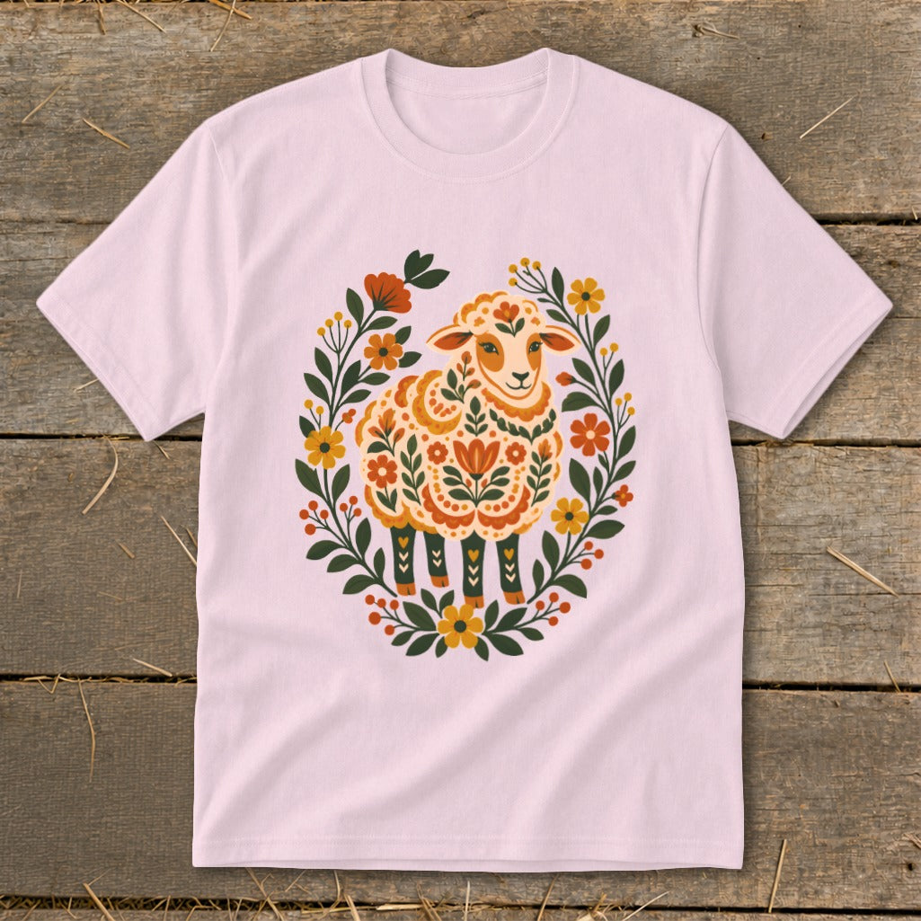 Pink t-shirt with folk art sheep surrounded by floral wreath.