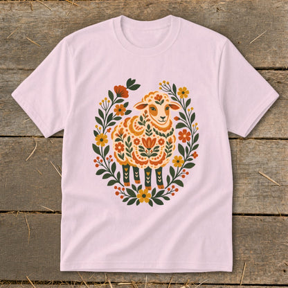 Pink t-shirt with folk art sheep surrounded by floral wreath.