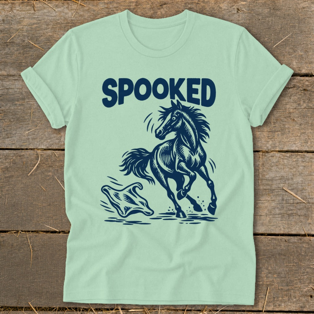 Light green t-shirt with dark blue graphic of a spooked horse and a ghost.