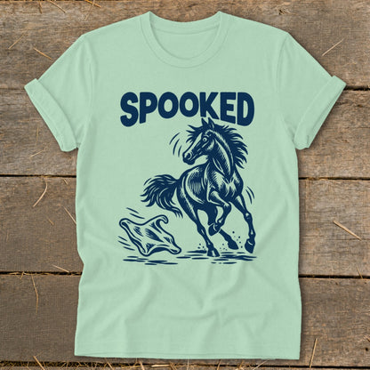 Light green t-shirt with dark blue graphic of a spooked horse and a ghost.