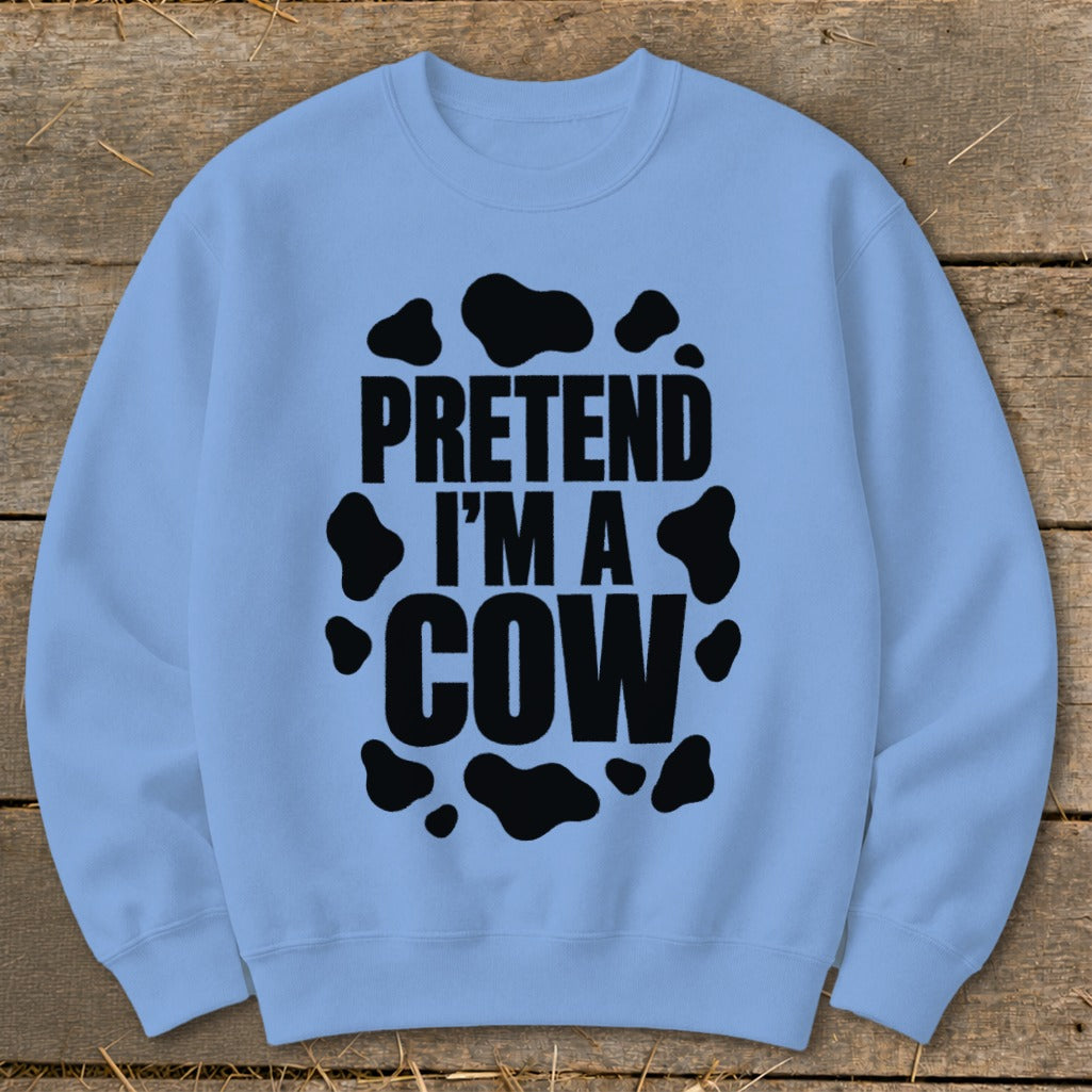Light blue sweatshirt with black "PRETEND I'M A COW" text and cow spots.