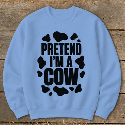 Light blue sweatshirt with black "PRETEND I'M A COW" text and cow spots.
