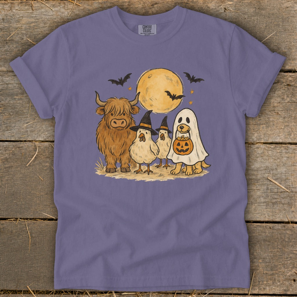 Highland cow, chickens, and dog in ghost costume with pumpkins under a moon.