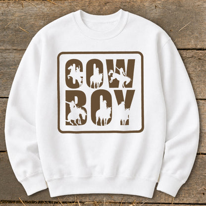White sweatshirt with brown "COW BOY" text, featuring cowboy silhouettes on horses.