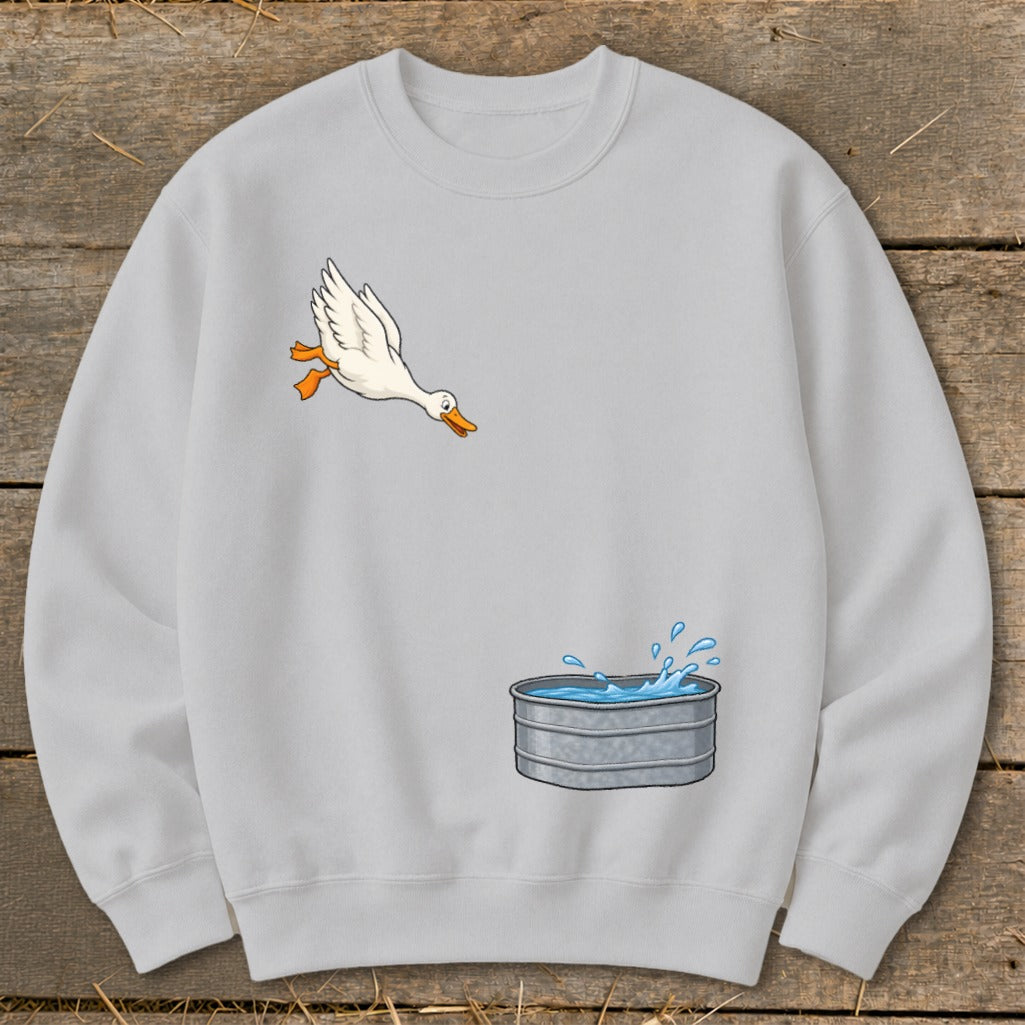 Light gray sweatshirt with cartoon of a duck flying towards a galvanized water tub.