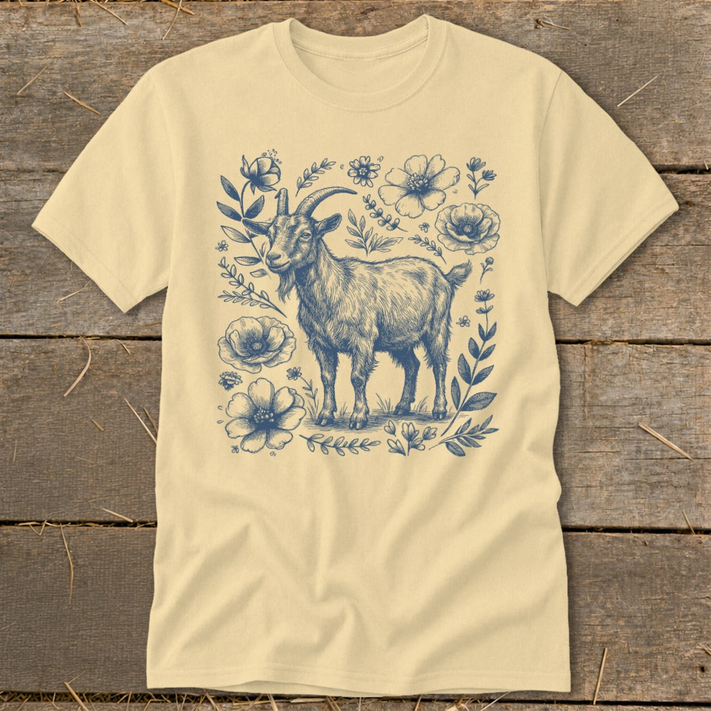 Cream t-shirt with blue sketch of a goat surrounded by flowers and leaves.