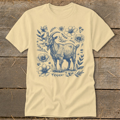 Cream t-shirt with blue sketch of a goat surrounded by flowers and leaves.