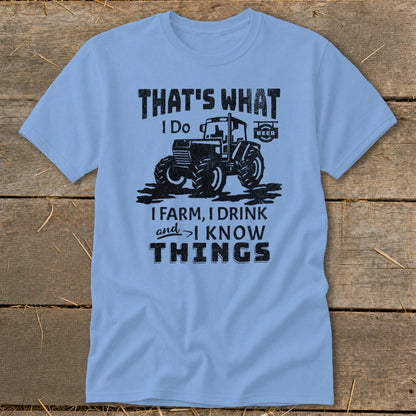 Light blue t-shirt with a black graphic of a tractor and text that says "That's What I Do, I Farm, I Drink and I Know Things".