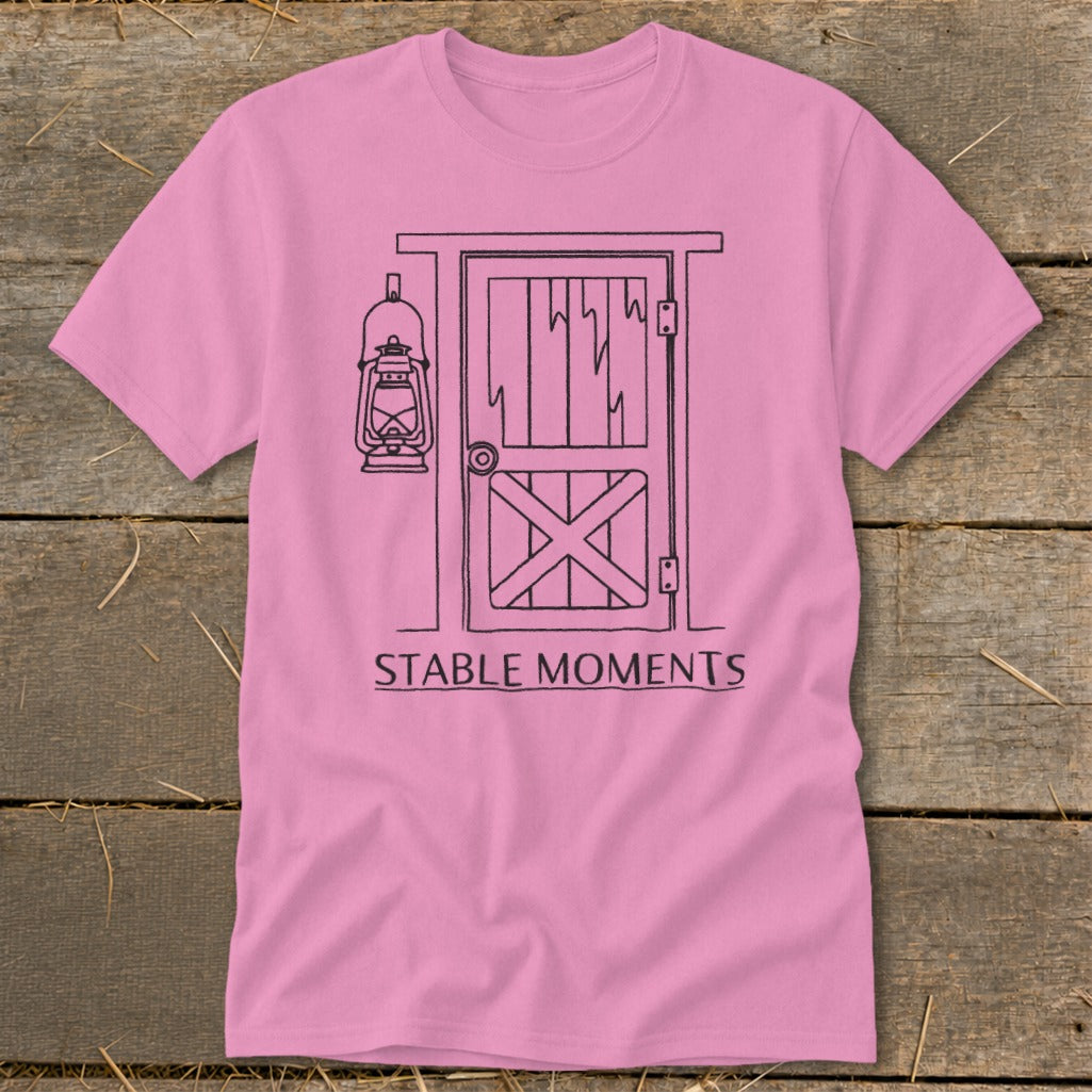 Pink t-shirt with barn door and lantern graphic and "STABLE MOMENTS" text.