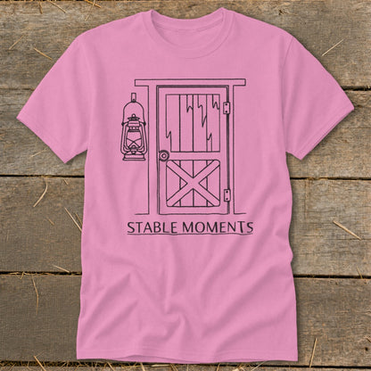 Pink t-shirt with barn door and lantern graphic and "STABLE MOMENTS" text.