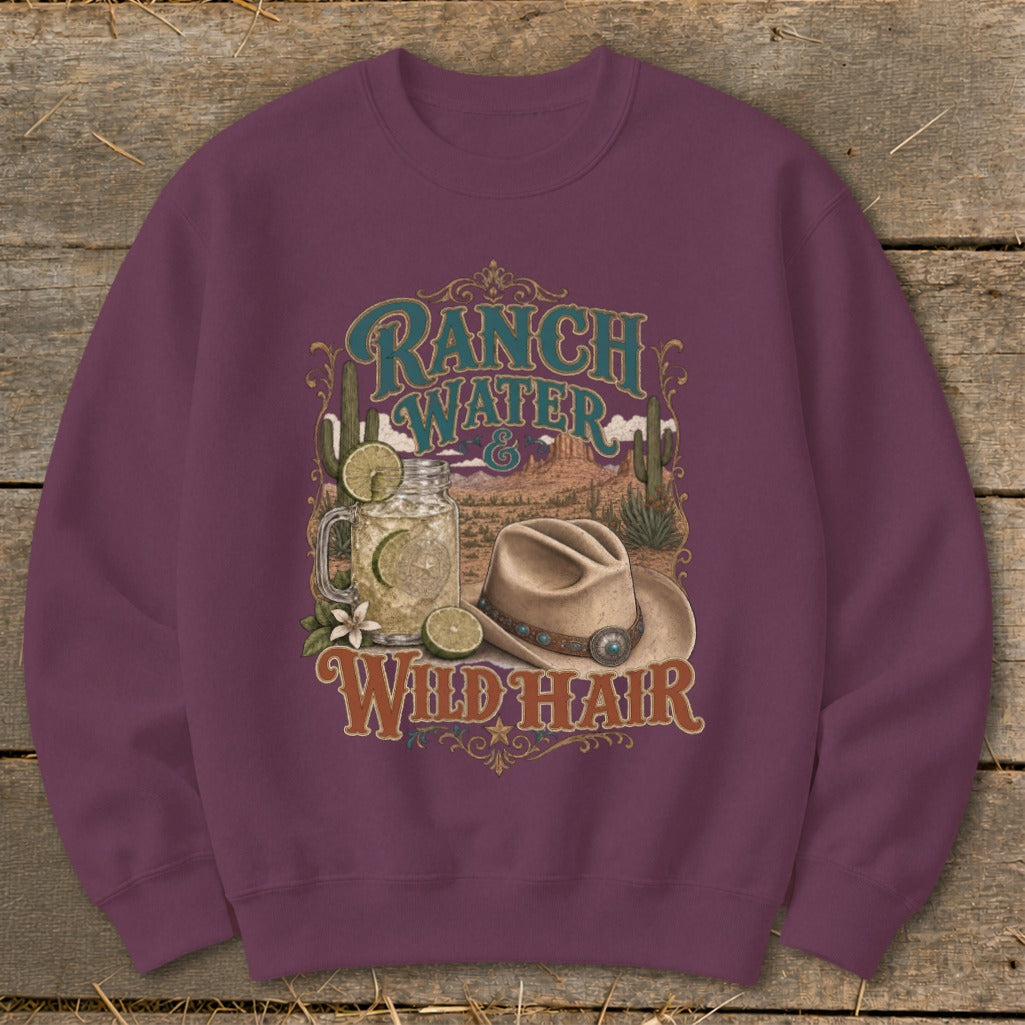 Maroon sweatshirt with "Ranch Water & Wild Hair" desert graphic and cowboy hat.