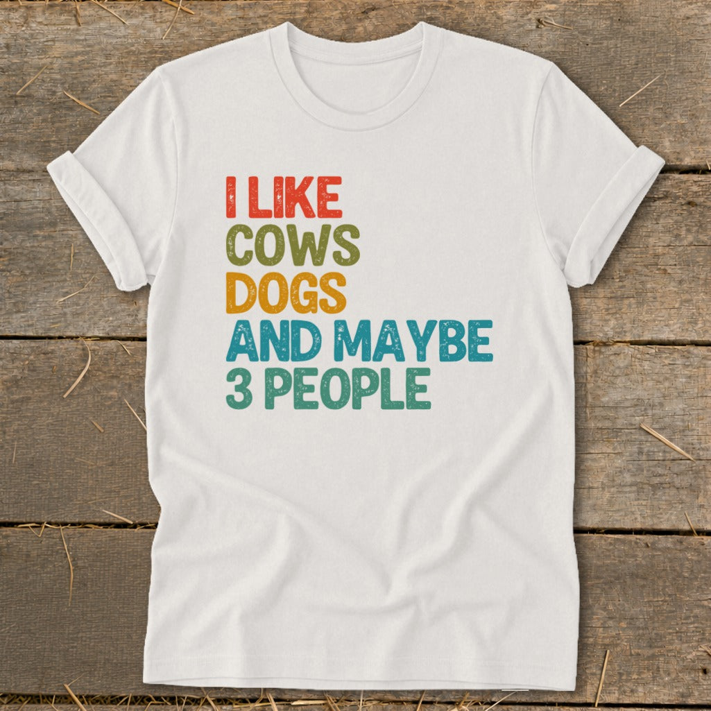 White t-shirt with text "I LIKE COWS DOGS AND MAYBE 3 PEOPLE".