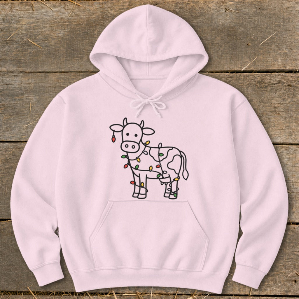 Pink hoodie with a line drawing of a cow wrapped in colorful holiday lights.