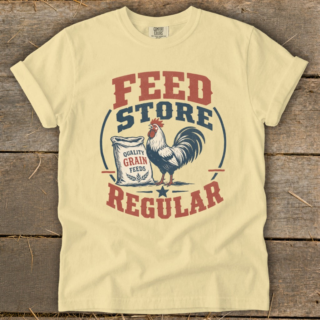 Yellow t-shirt with "FEED STORE REGULAR" text, rooster, and grain feed bag design.