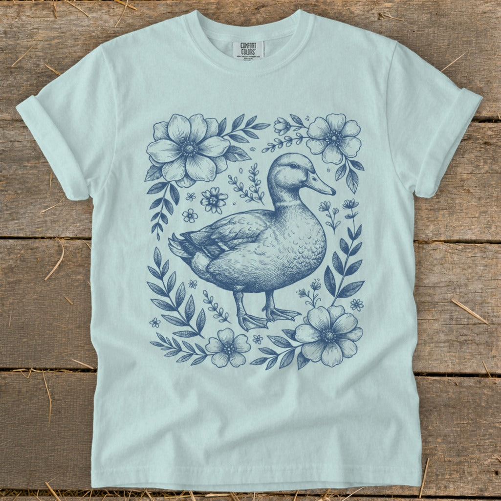 Light blue t-shirt with a navy blue duck and floral sketch design.