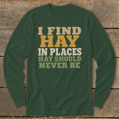 Green long-sleeve shirt with text "I FIND HAY IN PLACES HAY SHOULD NEVER BE".