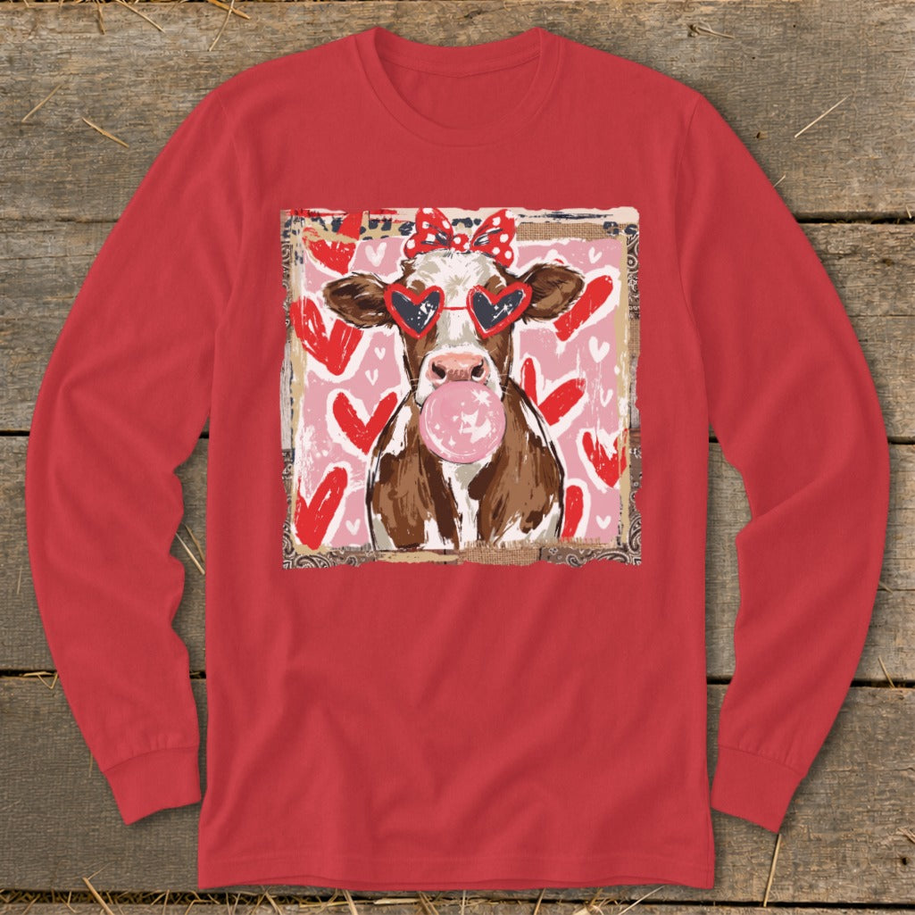 Cow wearing heart sunglasses and red bow blows pink bubblegum, with hearts background.