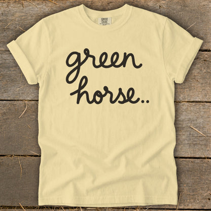 Light yellow t-shirt with black cursive text "green horse.."