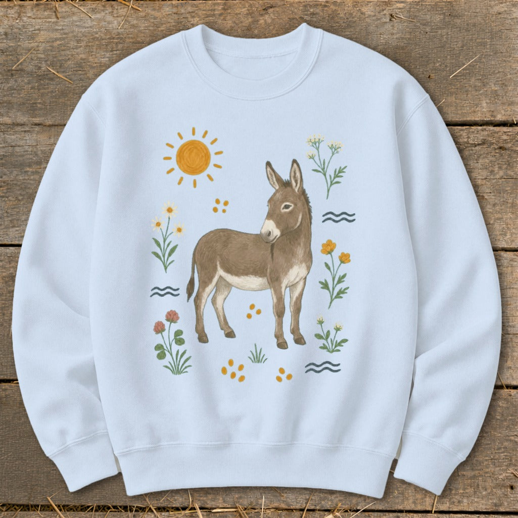 Light blue sweatshirt with a watercolor illustration of a donkey surrounded by flowers and sun.